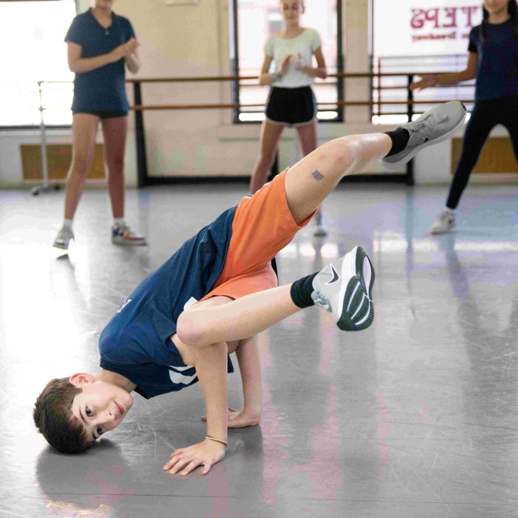 youth division dancer learning hip hop and street dance - head to the ground legs in the air