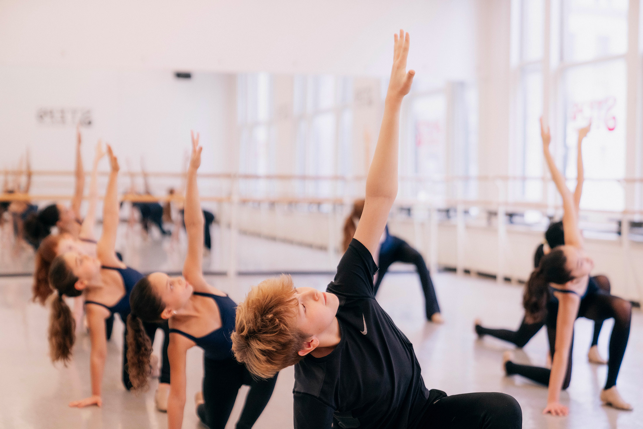 Steps Summer Intensive dance students in a bright studio practicing pilates