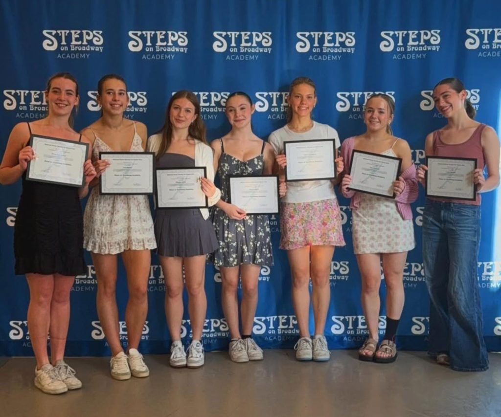 Seven Steps Academy dancers holding their certificates from their induction into the National Honors Society of Dance and Arts