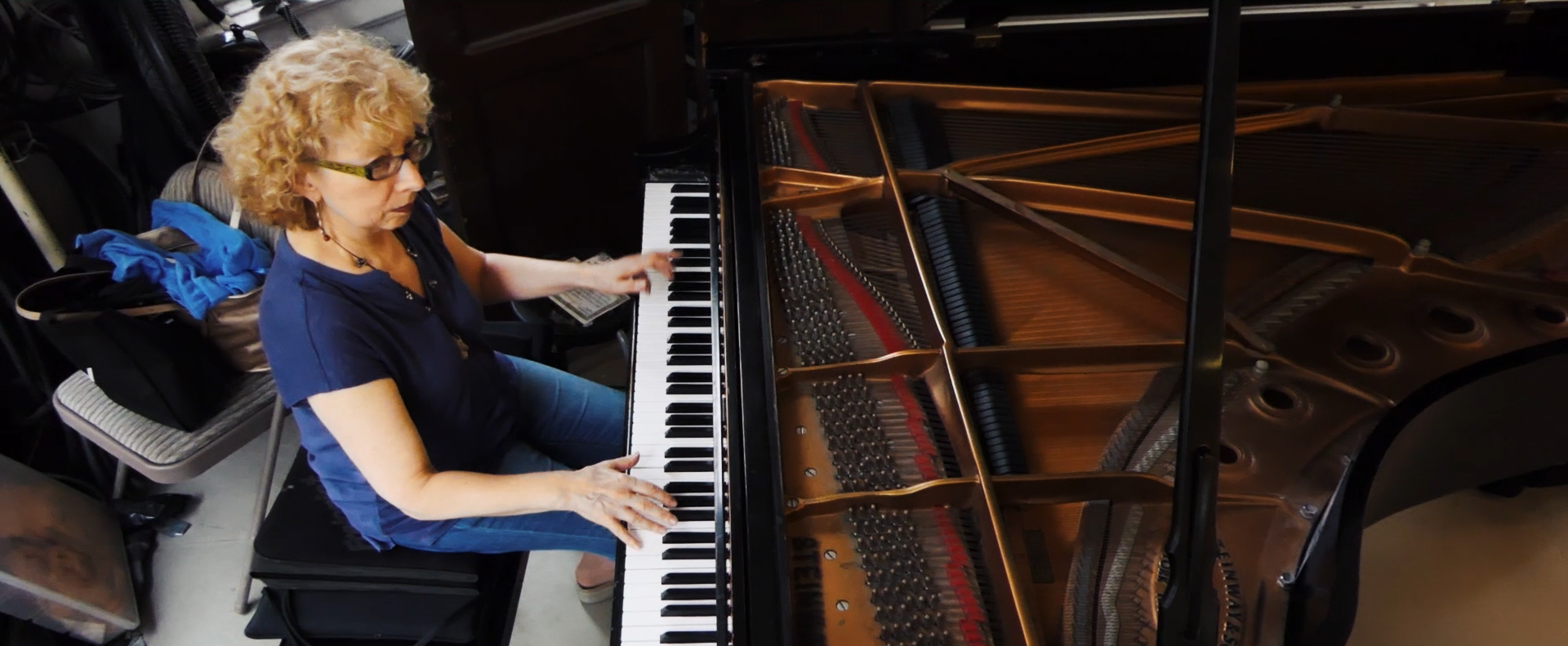 Olga Bazilevskaya photographed from above in casual attire playing piano