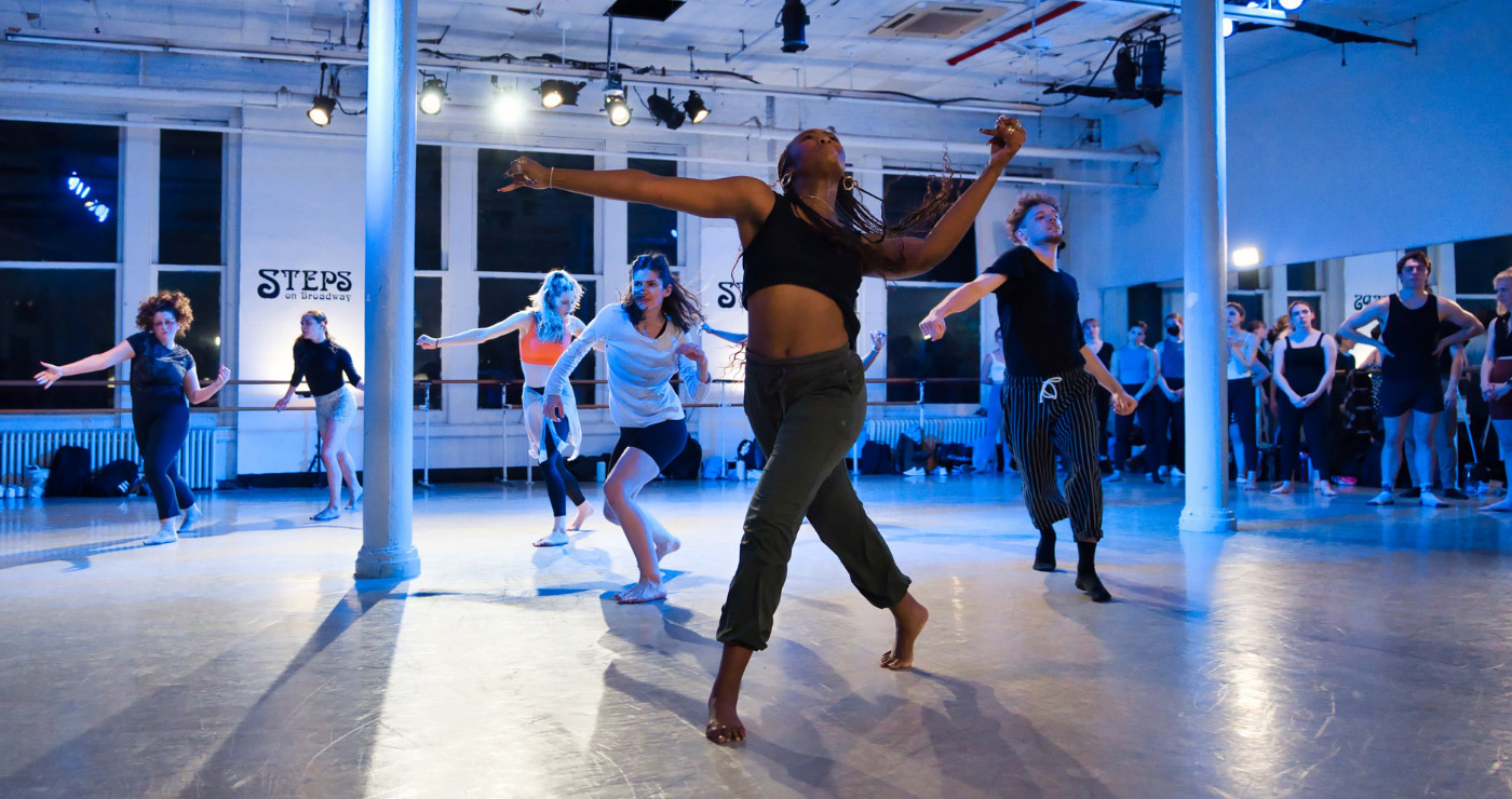 Several dancers engaged in a lively Spotlight dance class at Steps on Broadway.